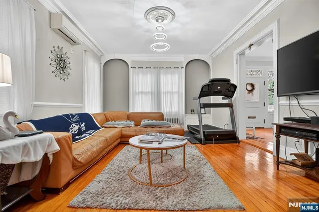a living room with furniture a flat screen tv and a rug
