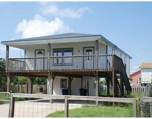a view of a house with wooden deck and a yard