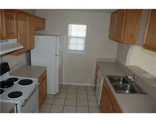 a kitchen with a refrigerator and a stove