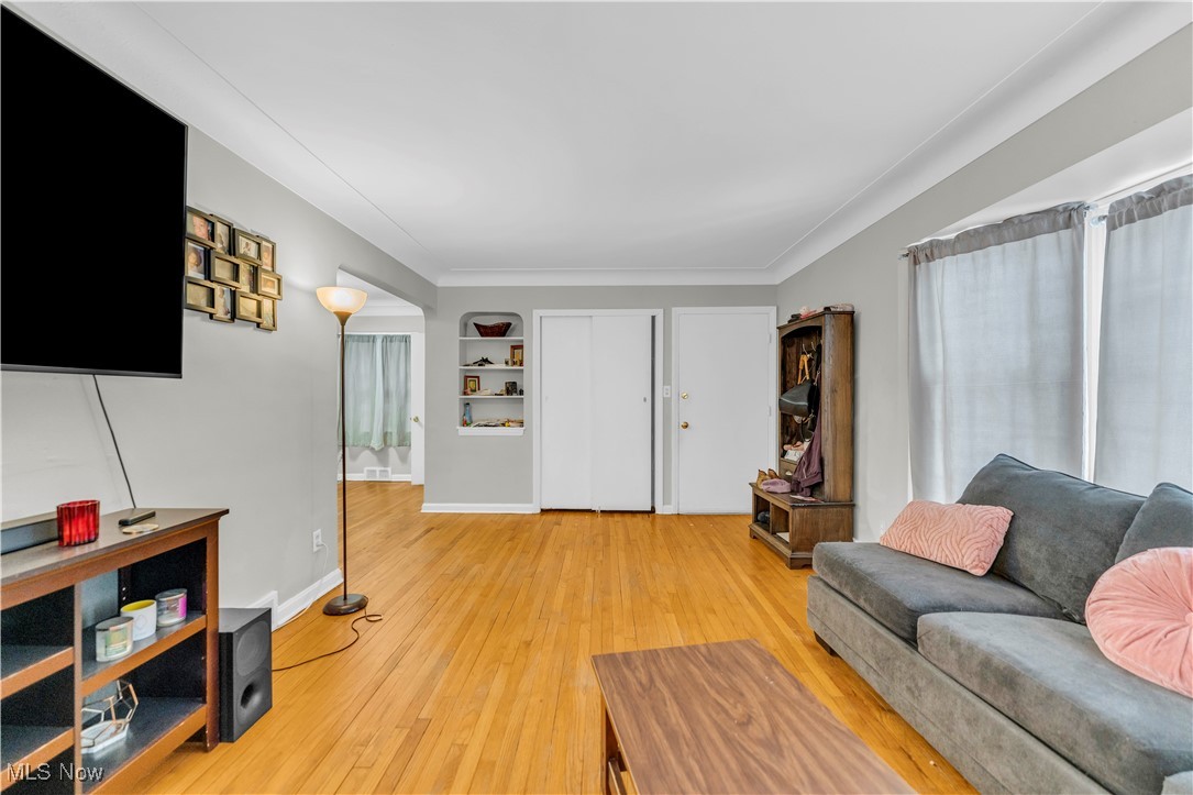 3597 Normandy Road Cleveland, OH 44120 - Photo 6 of 26 Living room featuring crown molding and wood-type flooring
