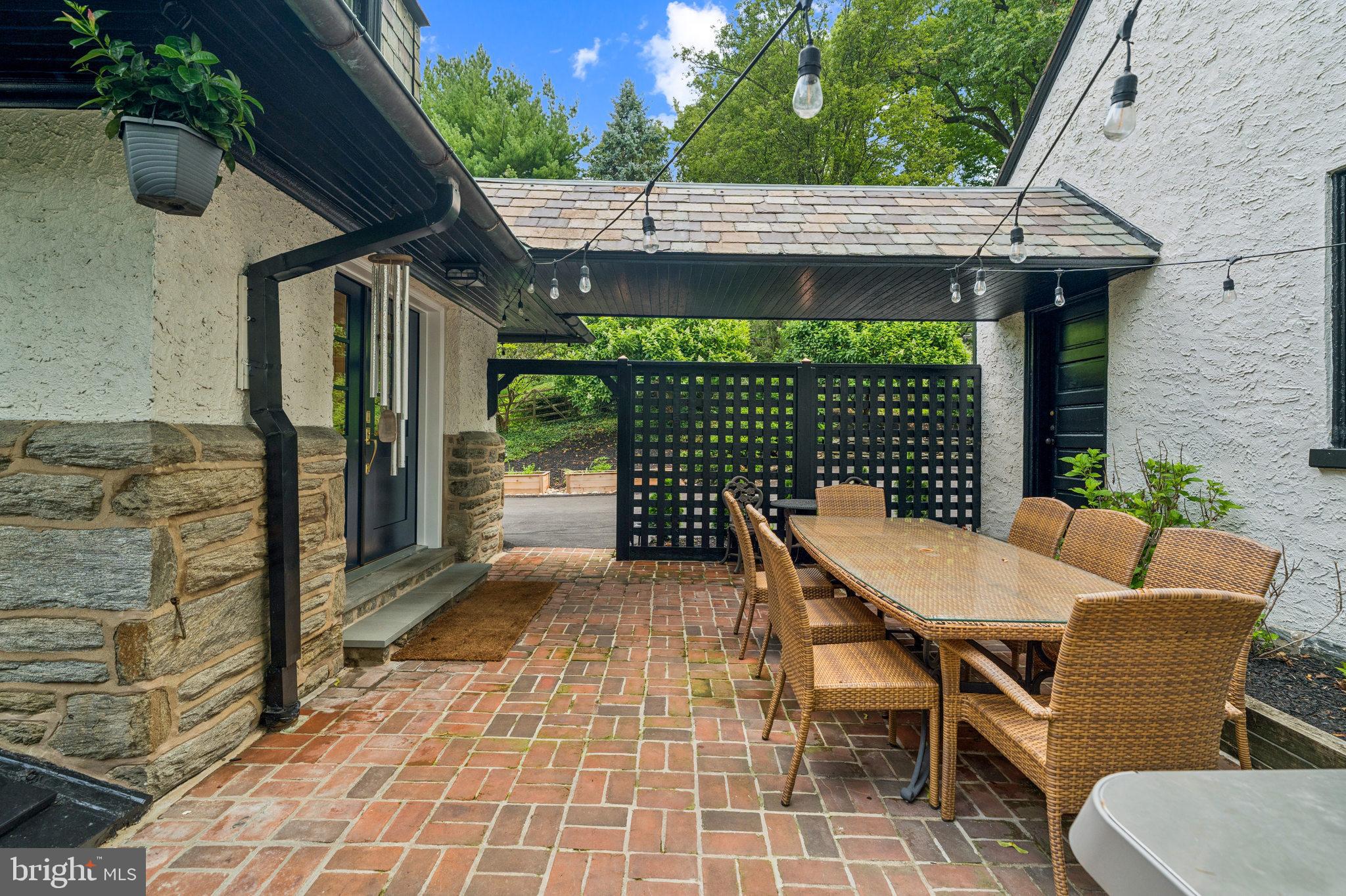 443 Homestead Road Wayne, PA 19087 - Photo 13 of 55 a view of a patio with table and chairs potted plants with wooden floor