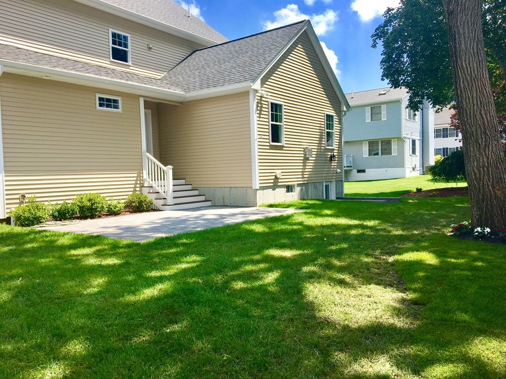 a backyard of a house with table and chairs