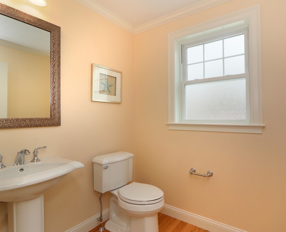6 Tower Road Arlington, MA 02474 - Photo 15 of 30 a white toilet sitting next to a bathroom sink