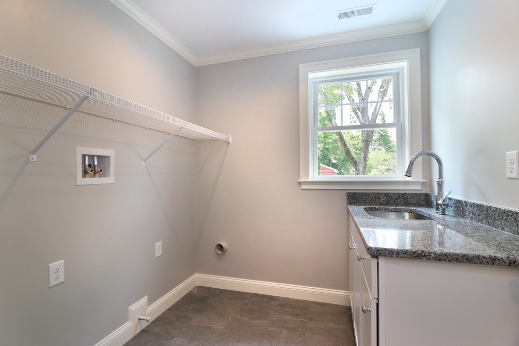 6 Tower Road Arlington, MA 02474 - Photo 17 of 30 a kitchen with granite countertop a sink window and cabinets