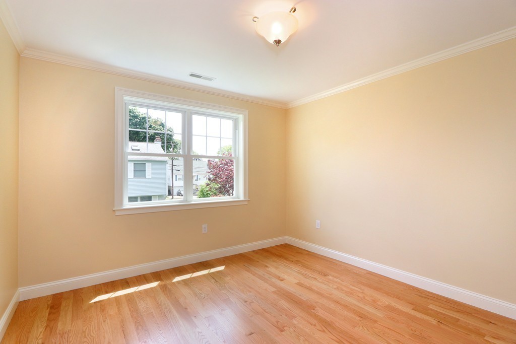 6 Tower Road Arlington, MA 02474 - Photo 21 of 30 a view of an empty room with wooden floor and a window
