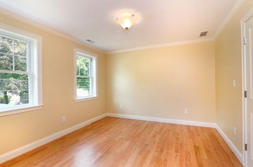 6 Tower Road Arlington, MA 02474 - Photo 23 of 30 an empty room with wooden floor and windows