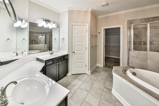 a bathroom with a tub sink and mirror