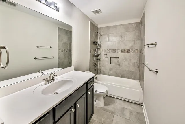 an empty room with windows and cabinet