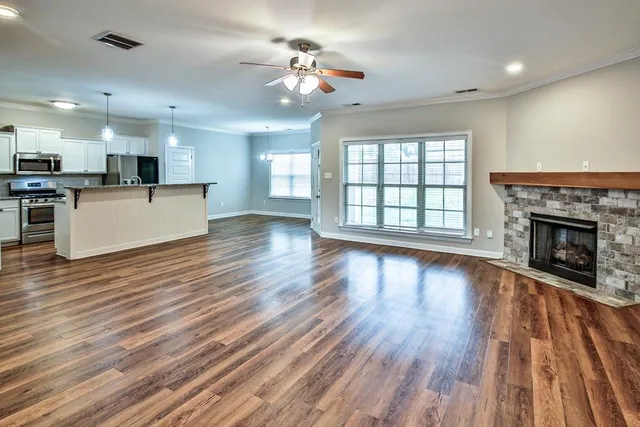 a kitchen with granite countertop a sink stainless steel appliances and cabinets