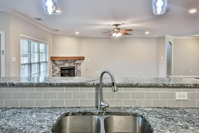 a close view of a faucet a sink and chandelier
