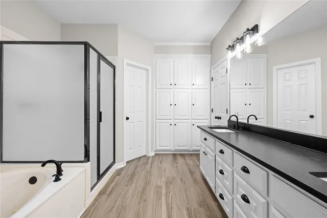 a kitchen with white cabinets and sink