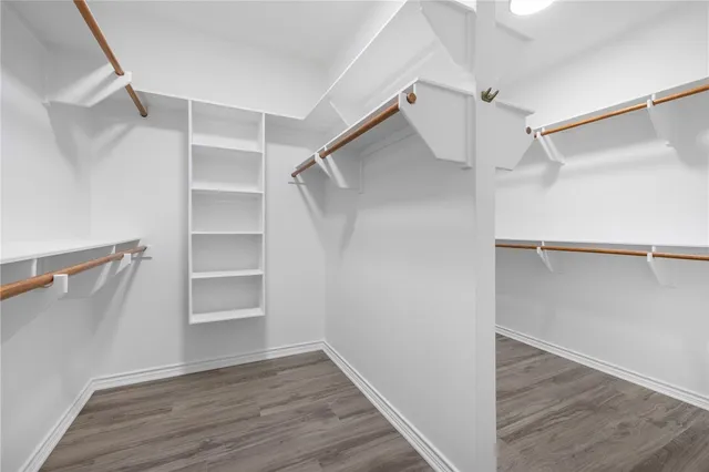 a view of walk in closet with empty racks