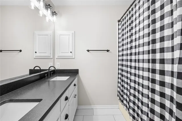 a kitchen with a sink window and cabinets