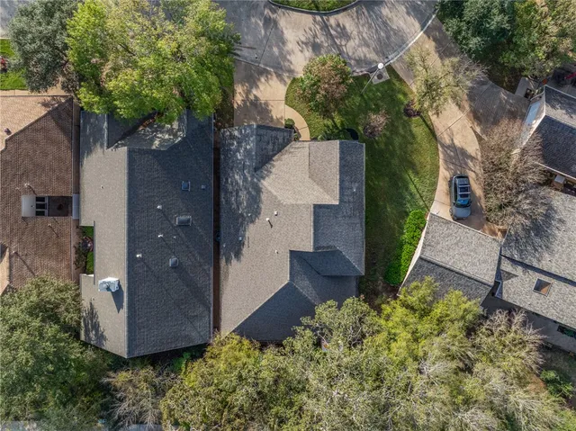 an aerial view of a house with garden space and street view