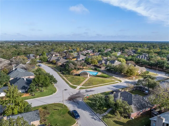 an aerial view of a house with a swimming pool