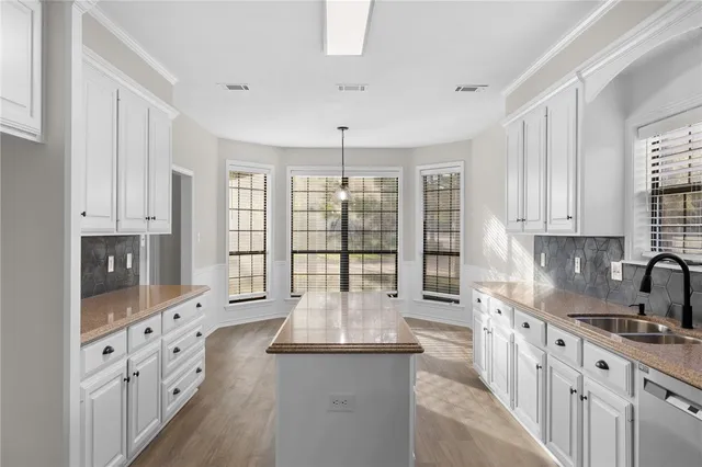 a kitchen with stainless steel appliances granite countertop a stove refrigerator and cabinets