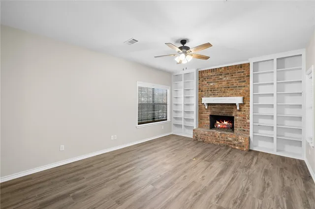 wooden floor in an empty room with a fireplace