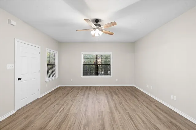 wooden floor in an empty room with a window