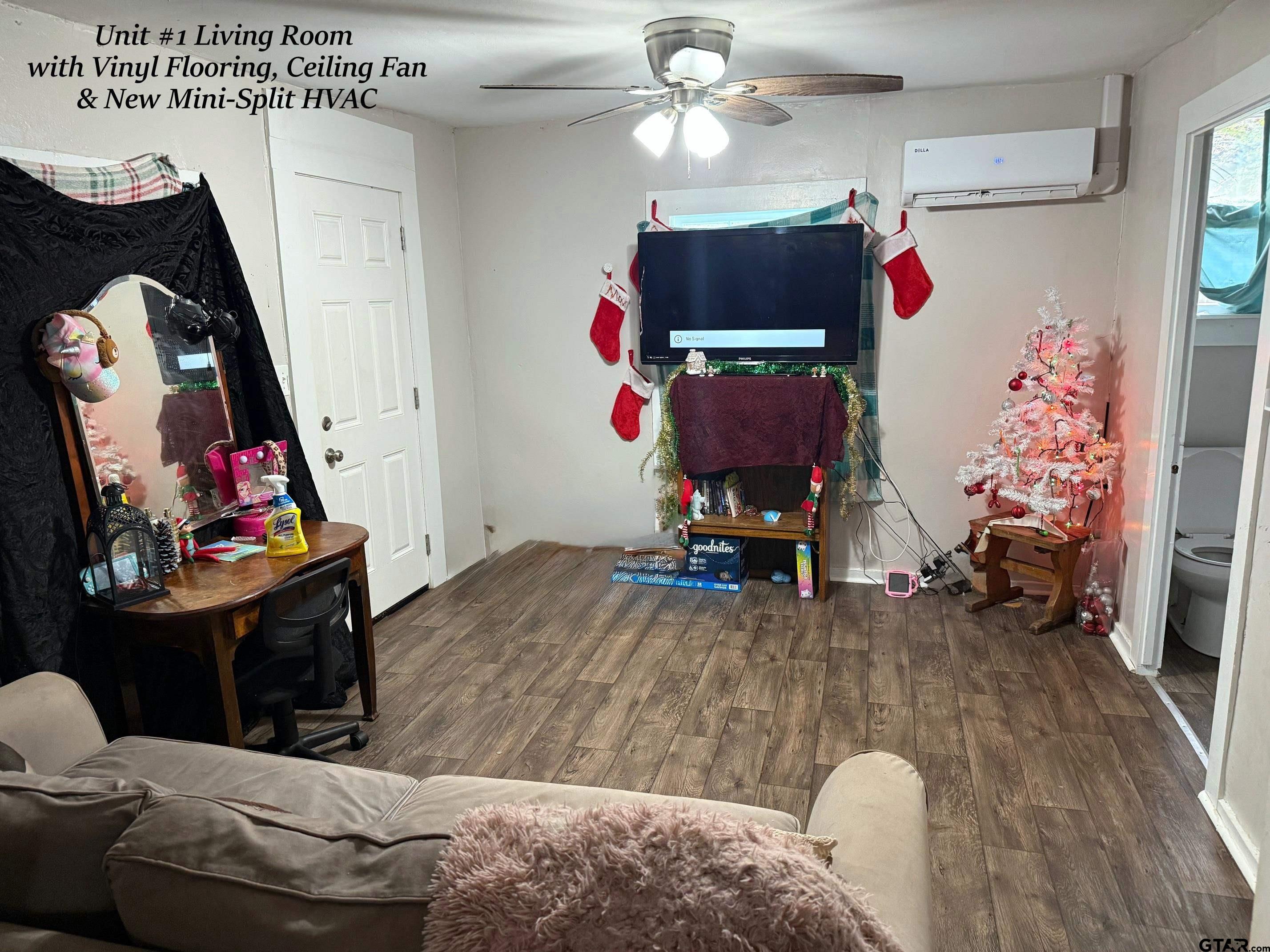 309 Brandon Street East Overton, TX 75684 - Photo 19 of 24 a living room with furniture and a flat screen tv