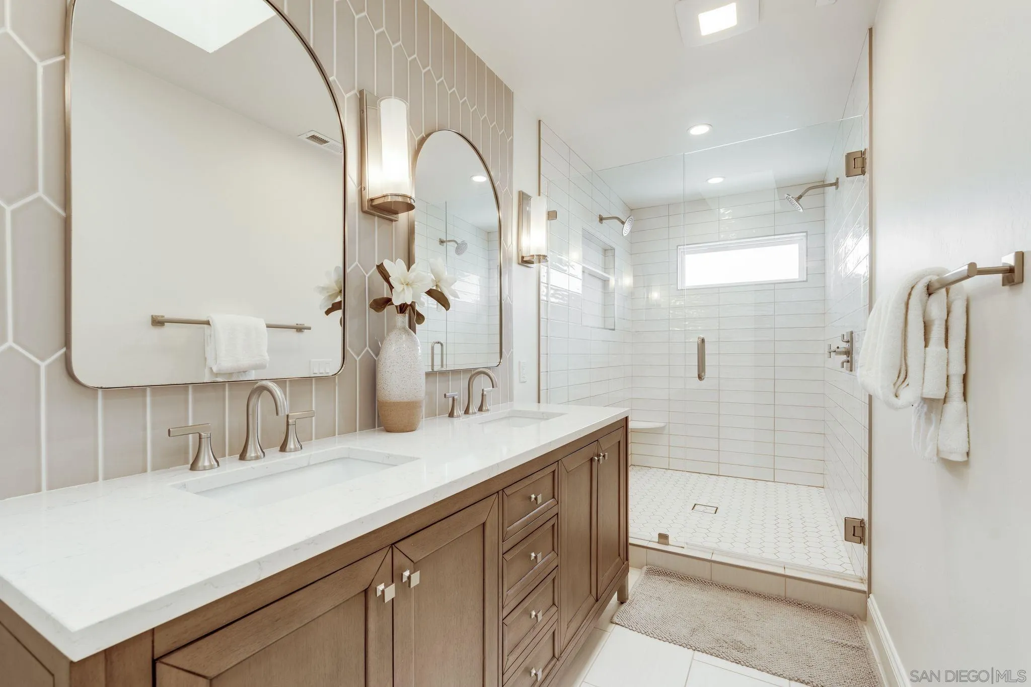 135 Little Oaks Road Encinitas, CA 92024 - Photo 54 of 59 a bathroom with a double vanity sink mirror double and shower