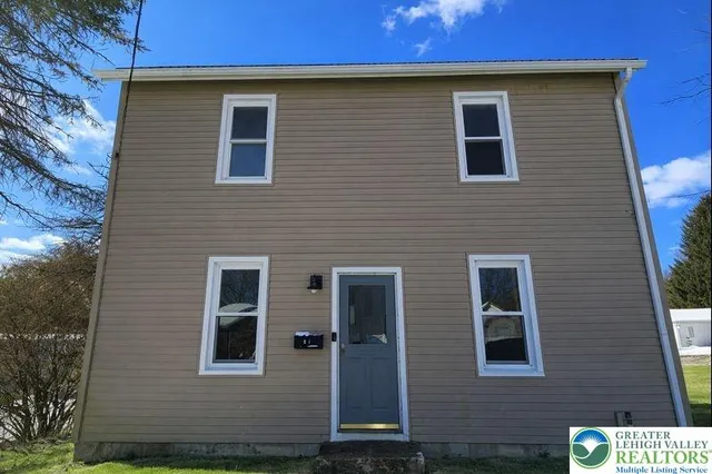 a front view of a house with stairs