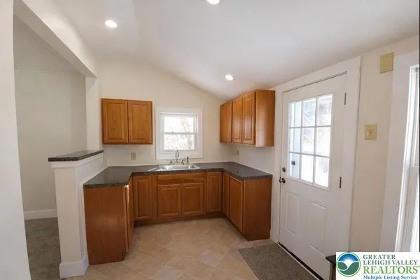 a kitchen with stainless steel appliances granite countertop a sink and cabinets