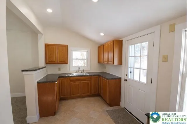 a kitchen with stainless steel appliances granite countertop a sink and cabinets