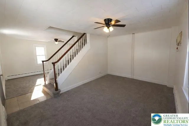 a view of entryway and hall with a fan