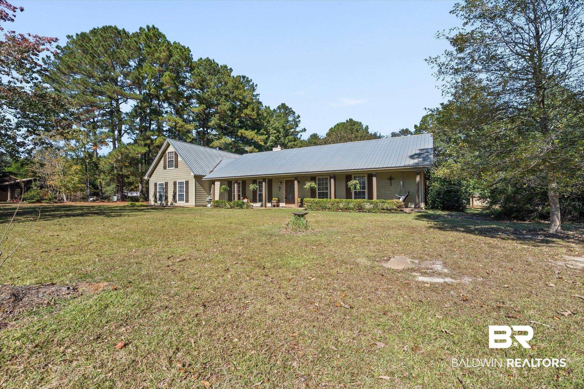 180 Creax Road Axis, AL 36505 - Photo 30 of 35 Ranch-style house with a porch, a metal roof, a front lawn, and a chimney