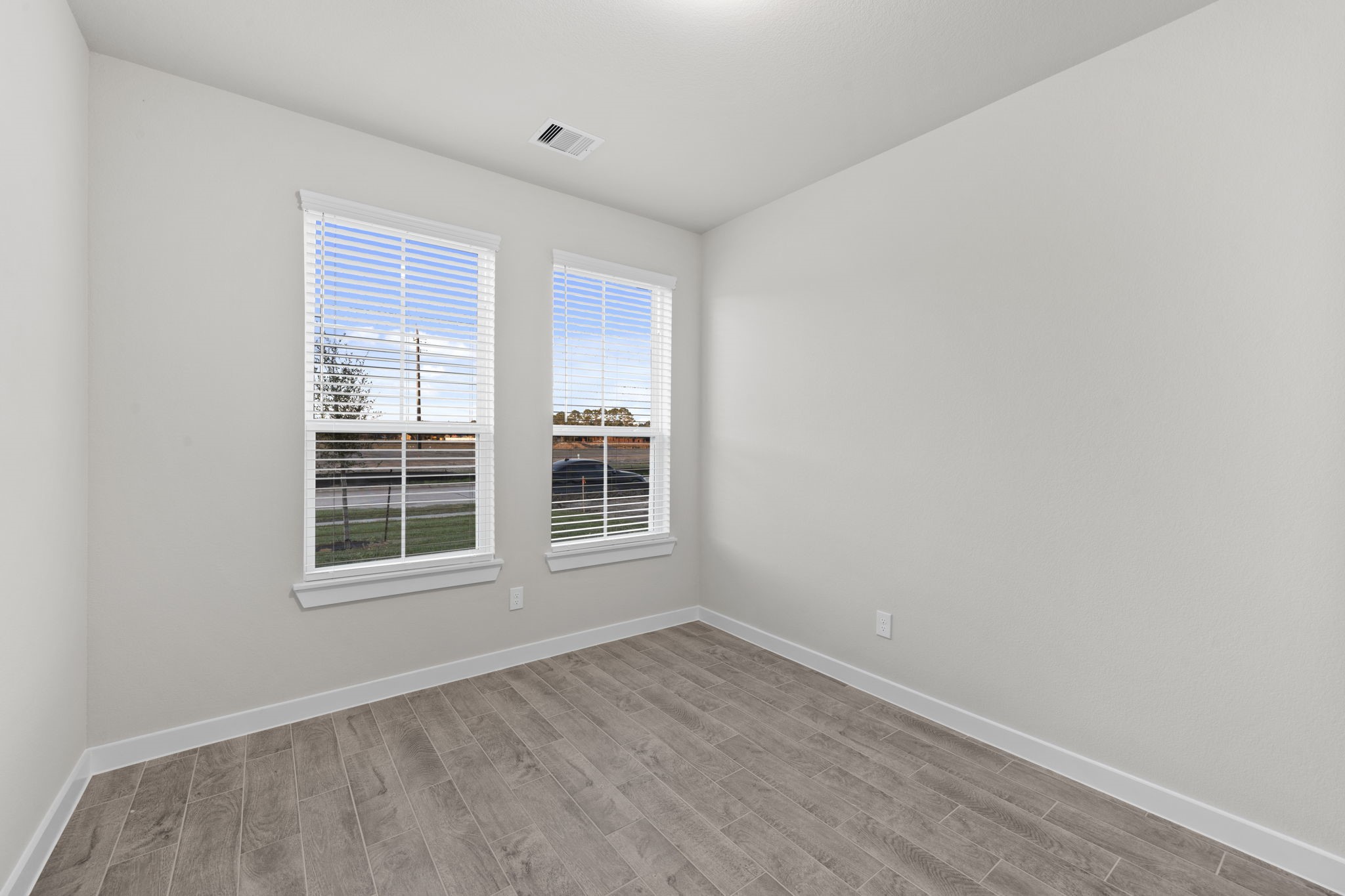 3015 Boulder Ridge Drive Rosenberg, TX 77471 - Photo 10 of 34 an empty room with wooden floor and windows