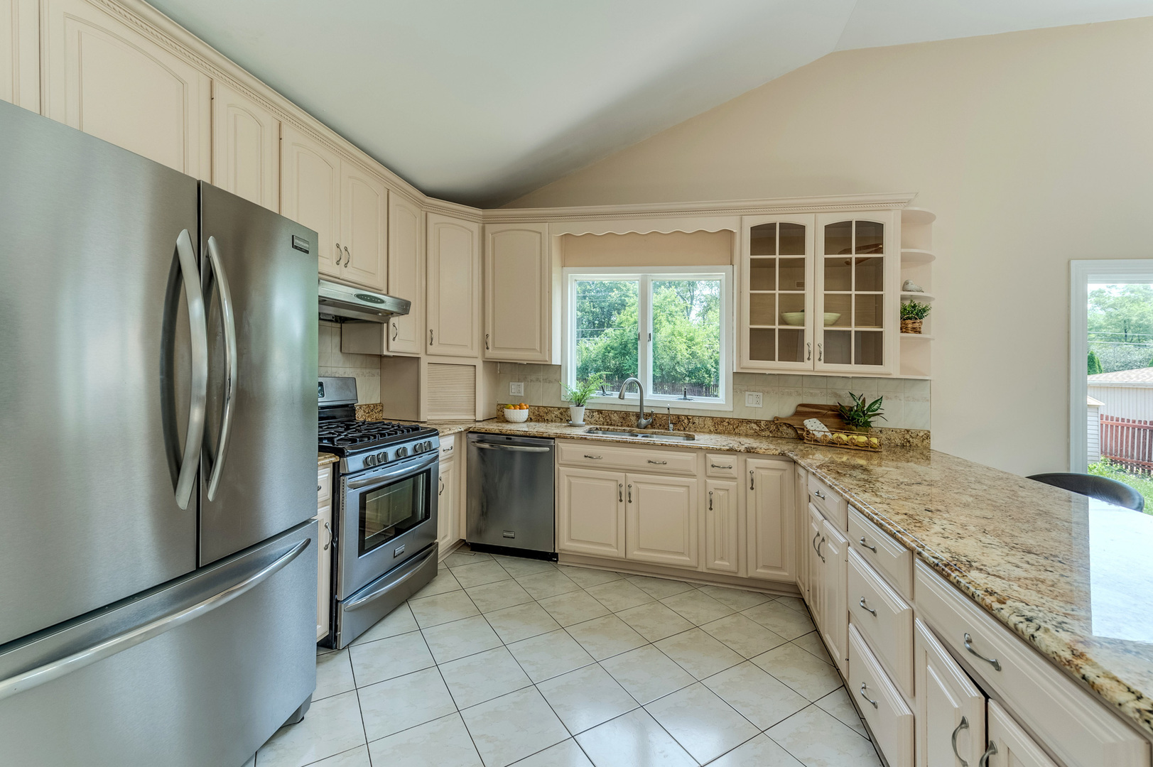 105 North Wolf Road Prospect Heights, IL 60070 - Photo 11 of 26 a kitchen with granite countertop stainless steel appliances a sink stove and refrigerator