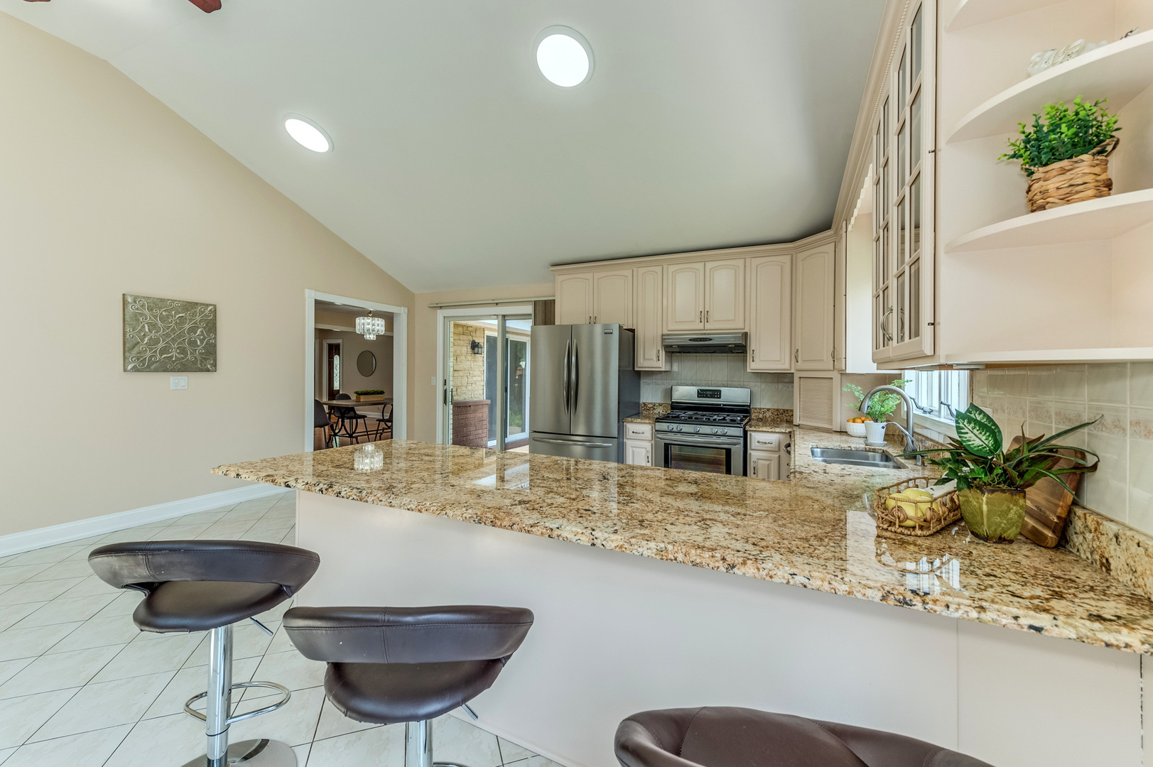 105 North Wolf Road Prospect Heights, IL 60070 - Photo 12 of 26 a kitchen with stainless steel appliances granite countertop a sink a stove a dining table and chairs