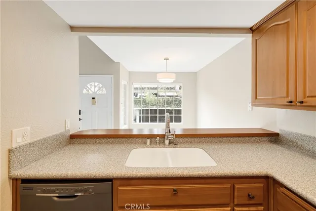 a view with granite countertop a sink and a window