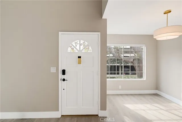 a view of an empty room with a fireplace and a window