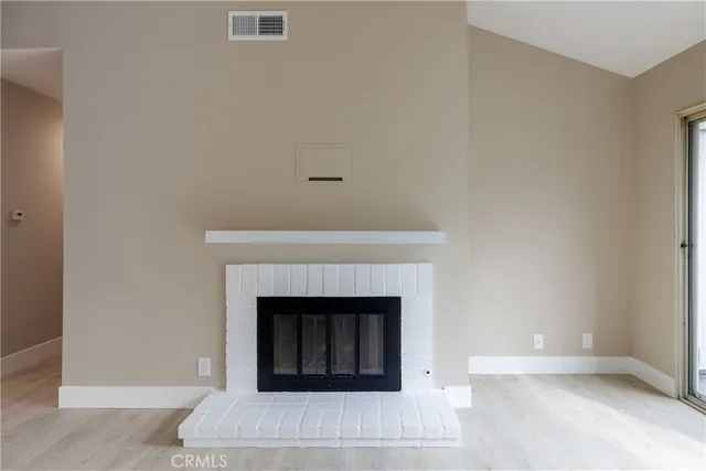 a view of an empty room and wooden floor