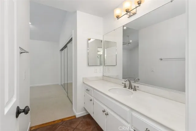 a bathroom with a sink toilet vanity and shower