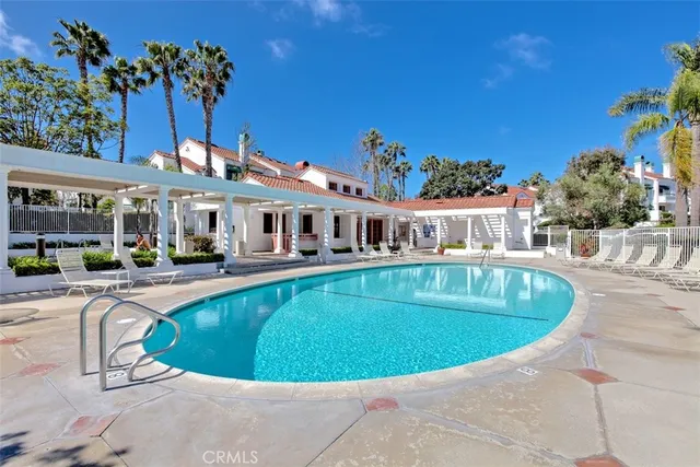 a backyard of a house with potted plants and large tree