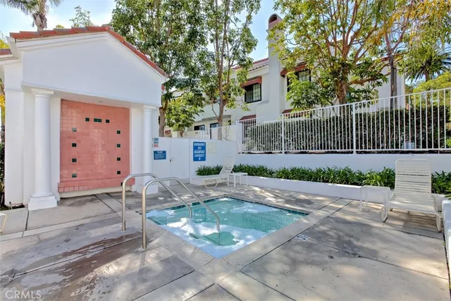a view of a patio with couches and table and chairs and potted plants