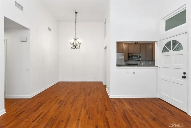 a view of a kitchen with wooden floor and a sink