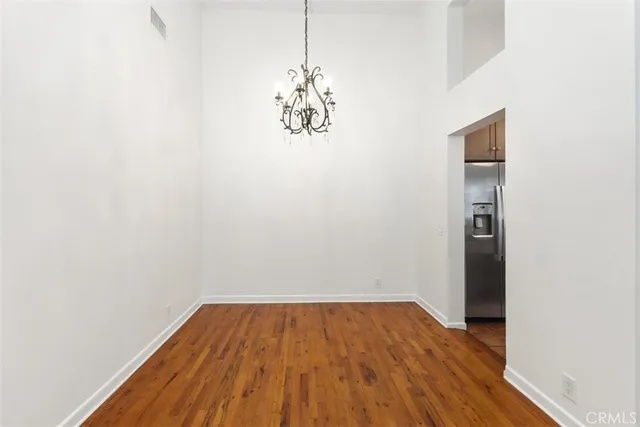a view of a room with wooden floor and a window