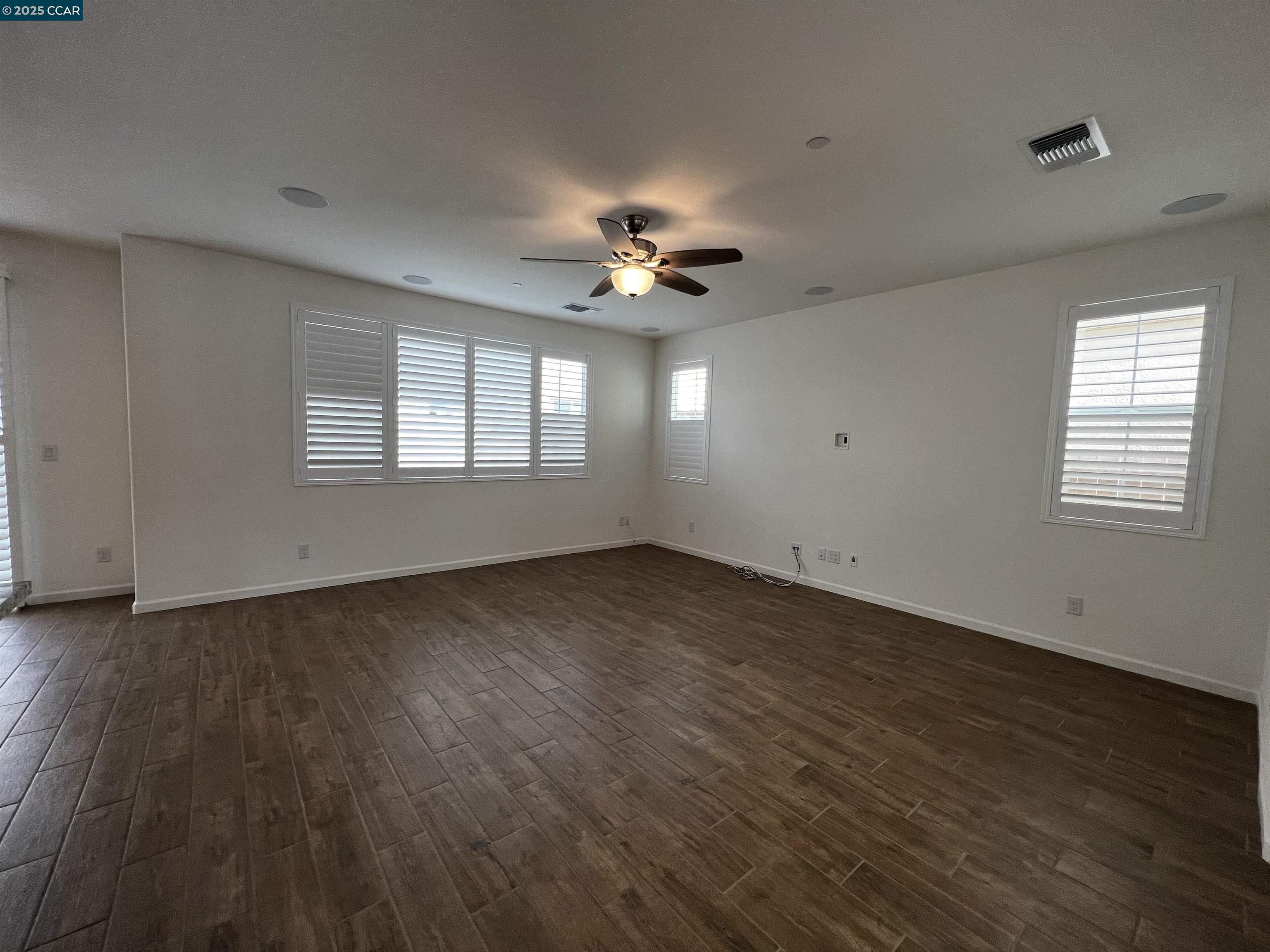 742 Iris Drive Vacaville, CA 95687 - Photo 7 of 23 an empty room with wooden floor and windows