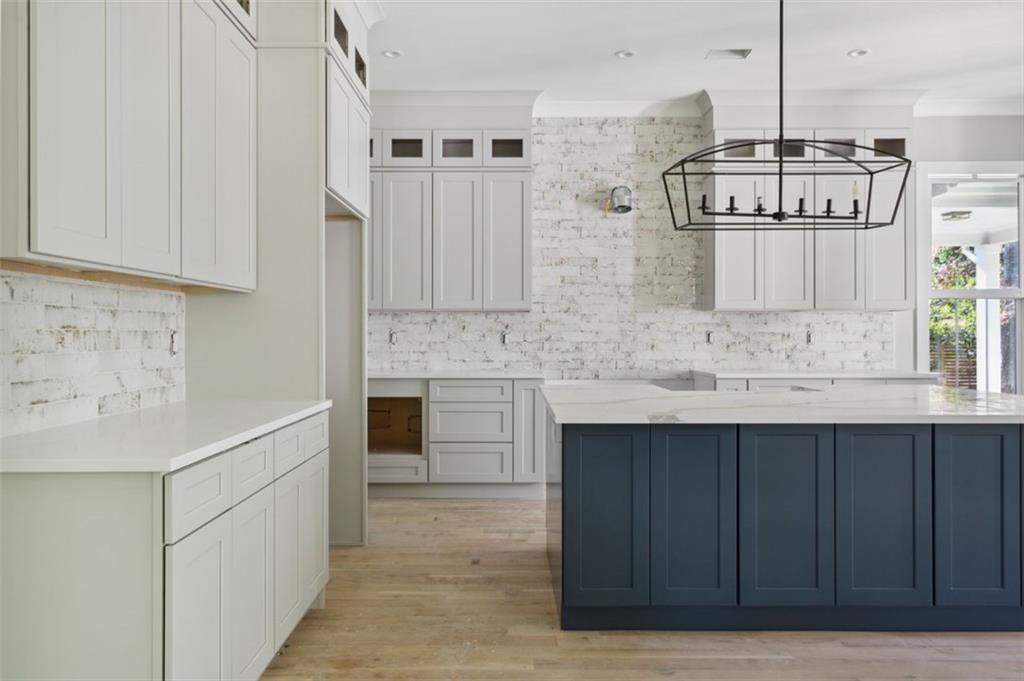 a kitchen with stainless steel appliances granite countertop a sink and cabinets
