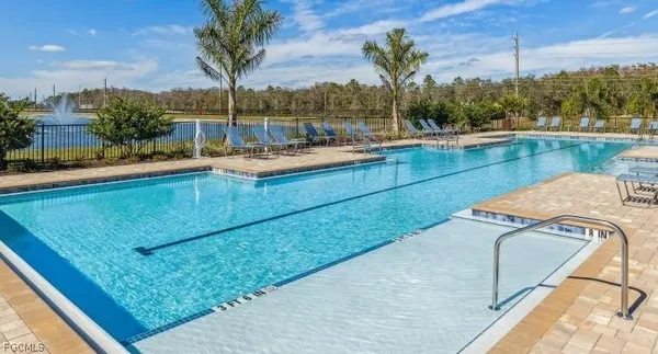 a large room with gym equipment and a table