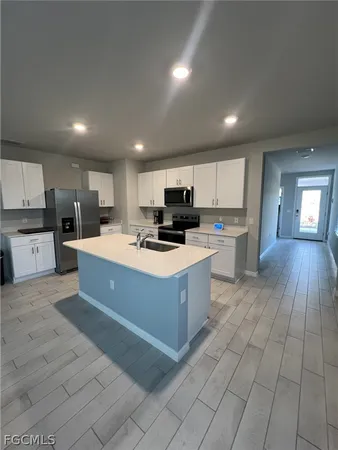 a large kitchen with stainless steel appliances lots of counter top space