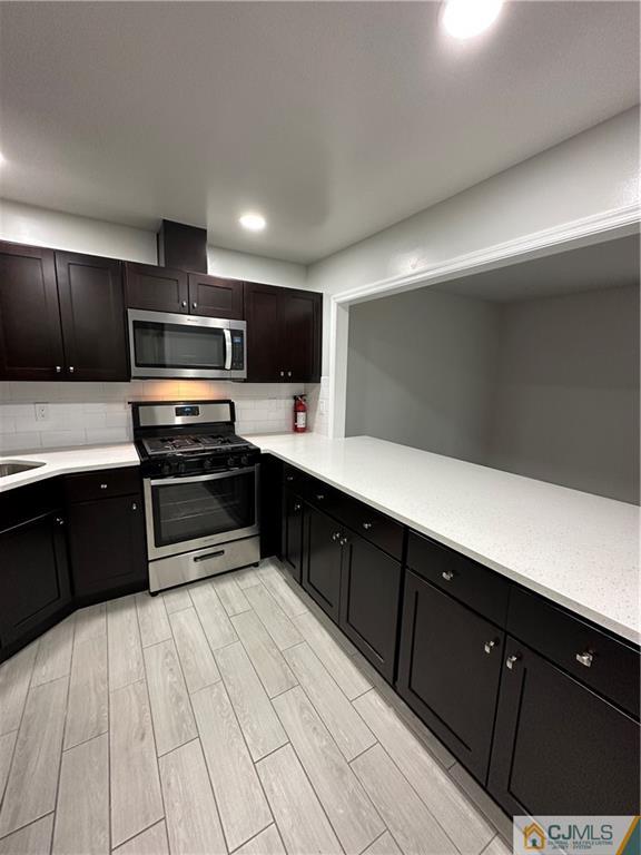 4202 Hana Road Edison, NJ 08817 - Photo 8 of 44 a kitchen with stainless steel appliances a refrigerator and a sink