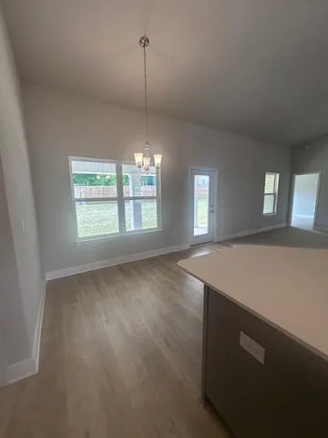 a view of an empty room with windows