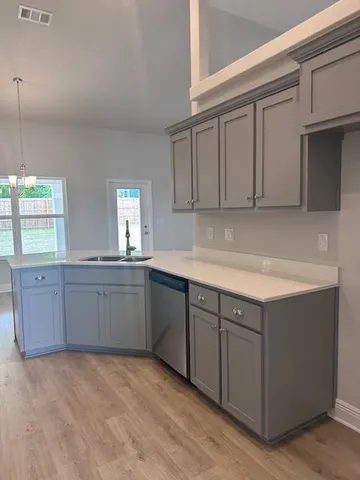 a kitchen with cabinets and window
