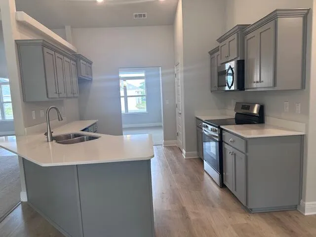 a kitchen with a sink stove top oven and cabinets