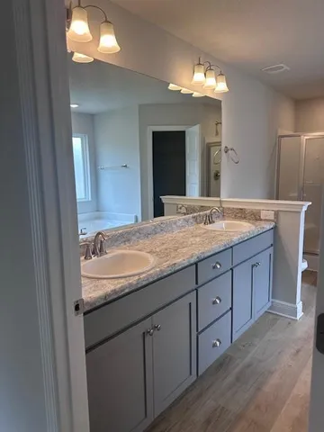 a bathroom with a granite countertop sink and a mirror