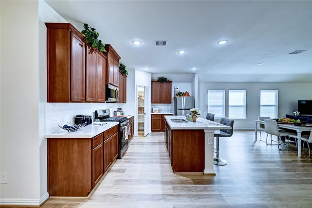 a living room with furniture and wooden floor